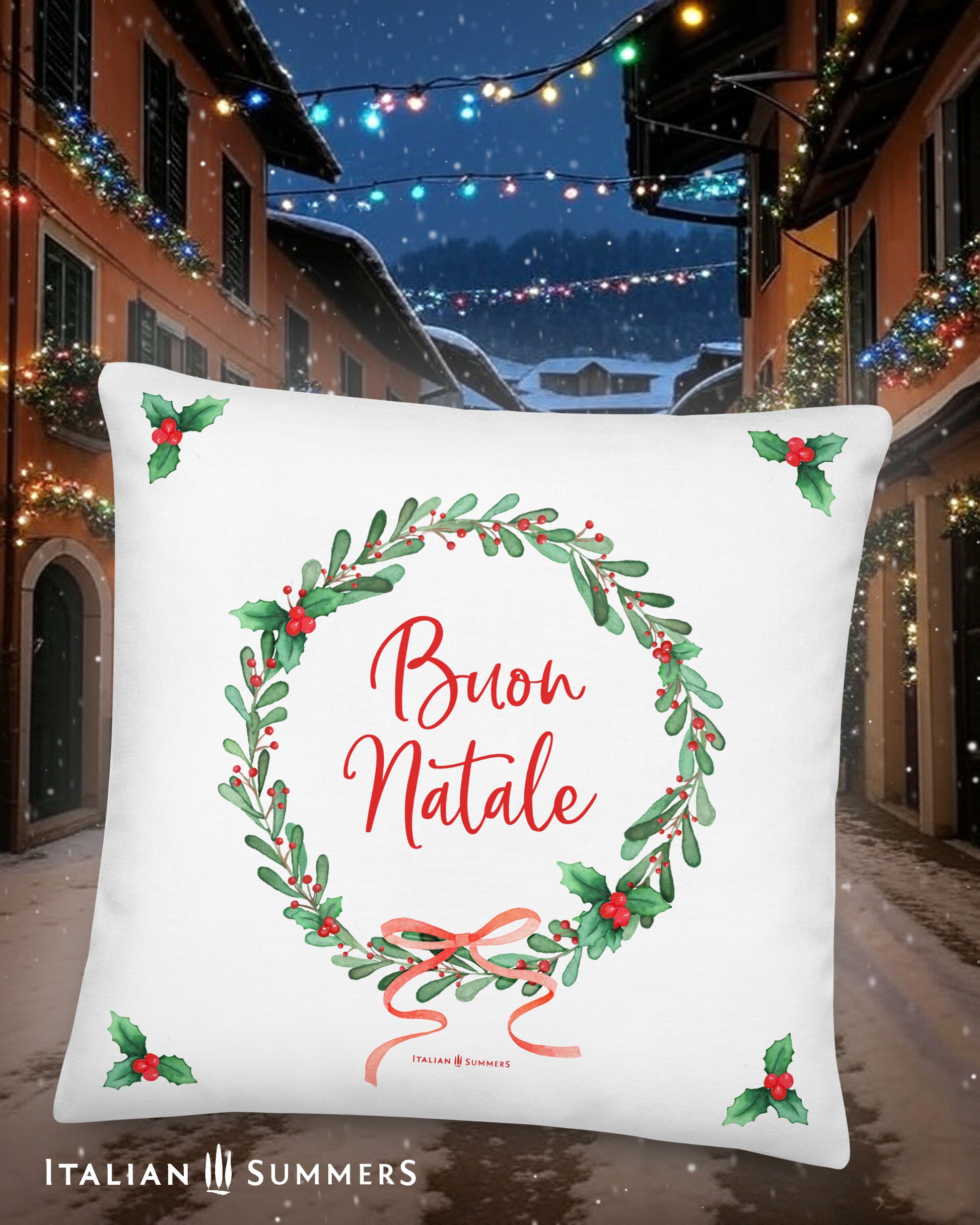 Decorative white  Italy pillow with 'Buon Natale' text and Christmas wreath design, set against a festive Italian village street background.