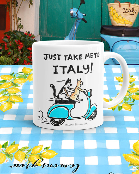 Italy inspired coffee mug with the quote "Just take me to Italy" with the sketch of two happy cats (one red and one black and white) driving a aqua blue vintage scooter and are on their way to Italy, Comes is 2 sizes 11oz and 15 oz. Made by Italian Summers