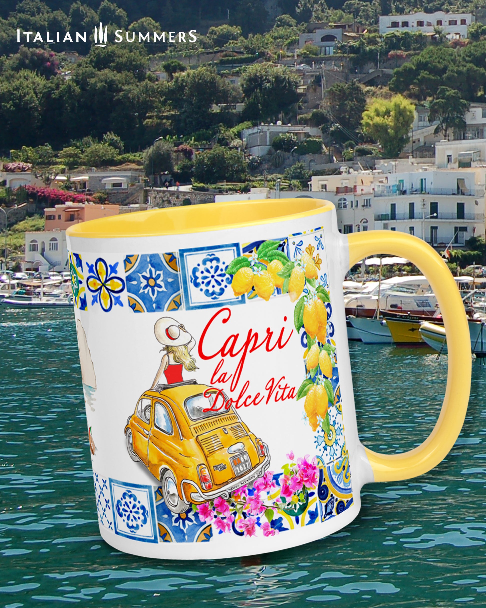 Capri inspired coffee mug with sketches of a yellow Cinquecento, the Faraglioni, a Riva and colorfu colorfull beach umbrellas. The rim is of the mug is decorated with Italian tiles and lemons. There is a lady in the Cinquecento who stand out of the sunroof. She has a hat and looks at the Faraglioni. Near the Yellow Cinquecento the is the writing Capri la Dolce Vita. The coffee mug is available with a colored inside and handle in the colors blue, yellow and pink. Made by Italian Summers.