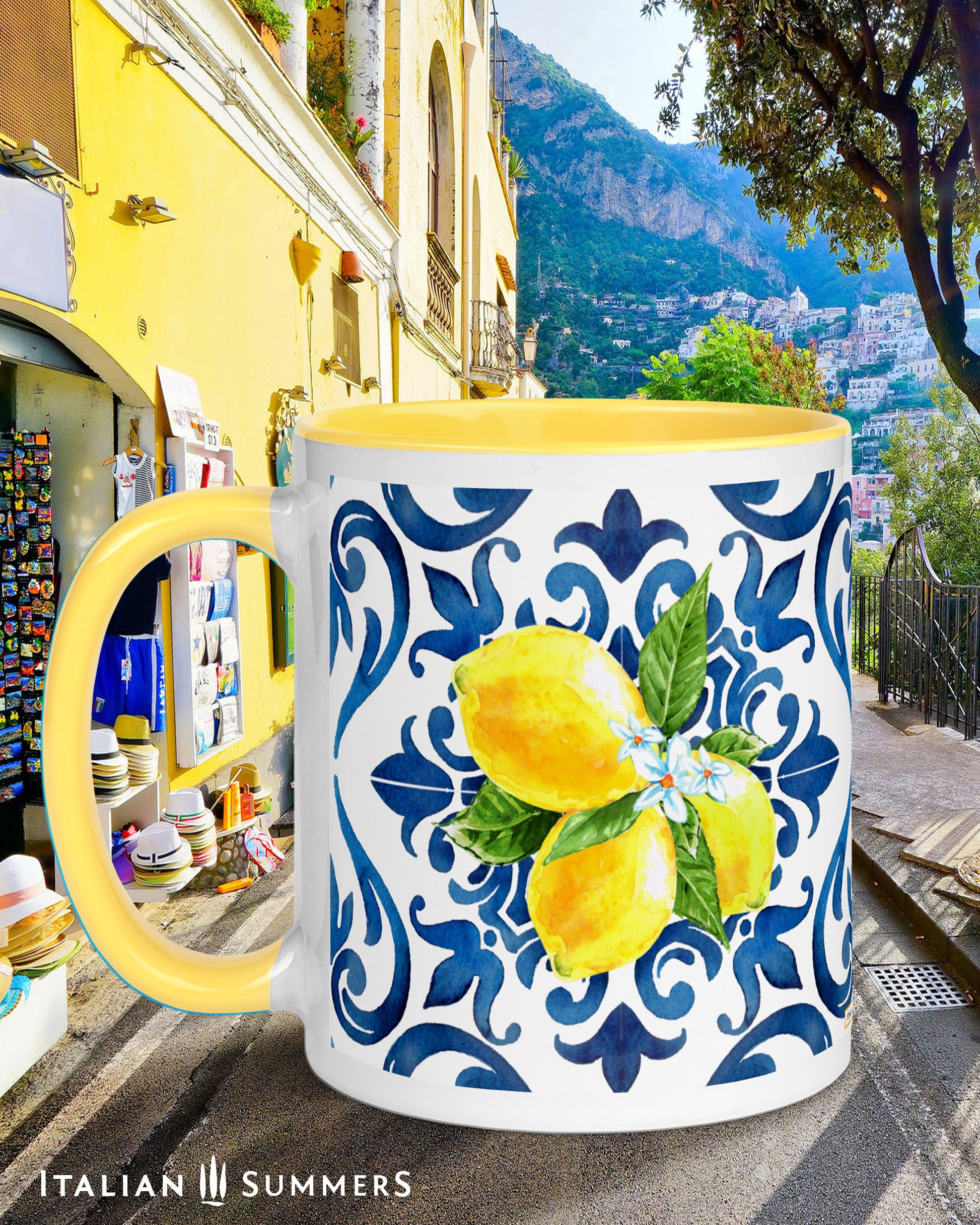 Italy inspired white ceramic mug with blue hande and interior. Italian blue tile pattern printed on the outside with bunches of sunny Sorrento lemons with flowers . Made by Italian Summers