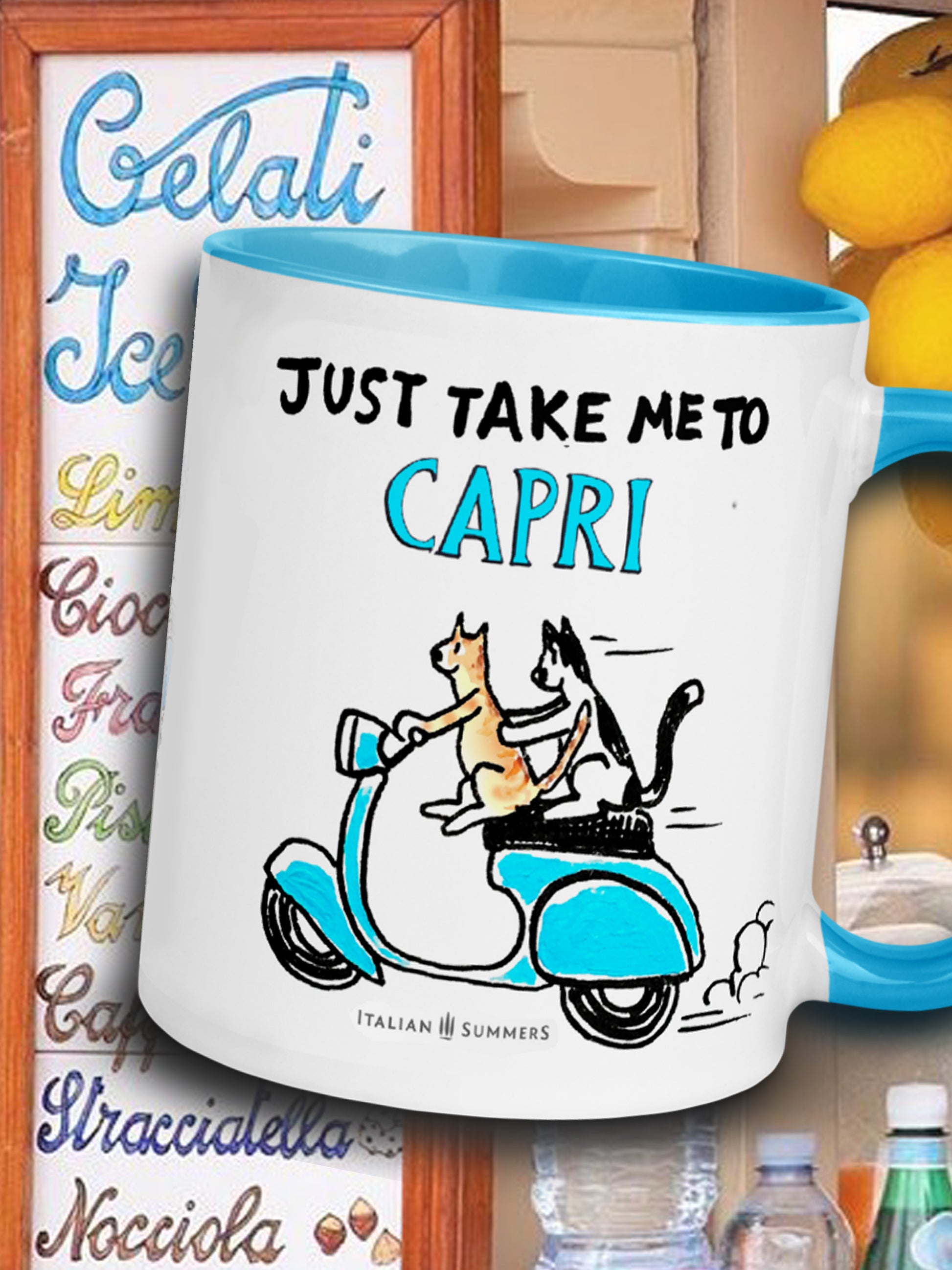 An Italy inspired coffe mug with the text Just take me to Capri. With a sketch of two cats driving an aqua blue vintage Vespa. The mug is avai;able in white or with a yellow or blue inside/handle. Made by Italian Summers