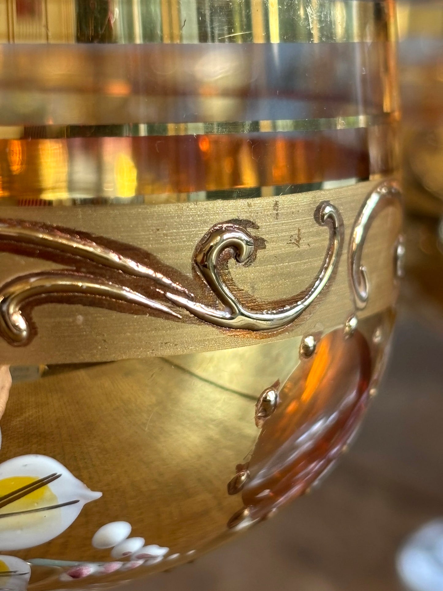 Close-up of a decorative gold crystal goblet with intricate designs