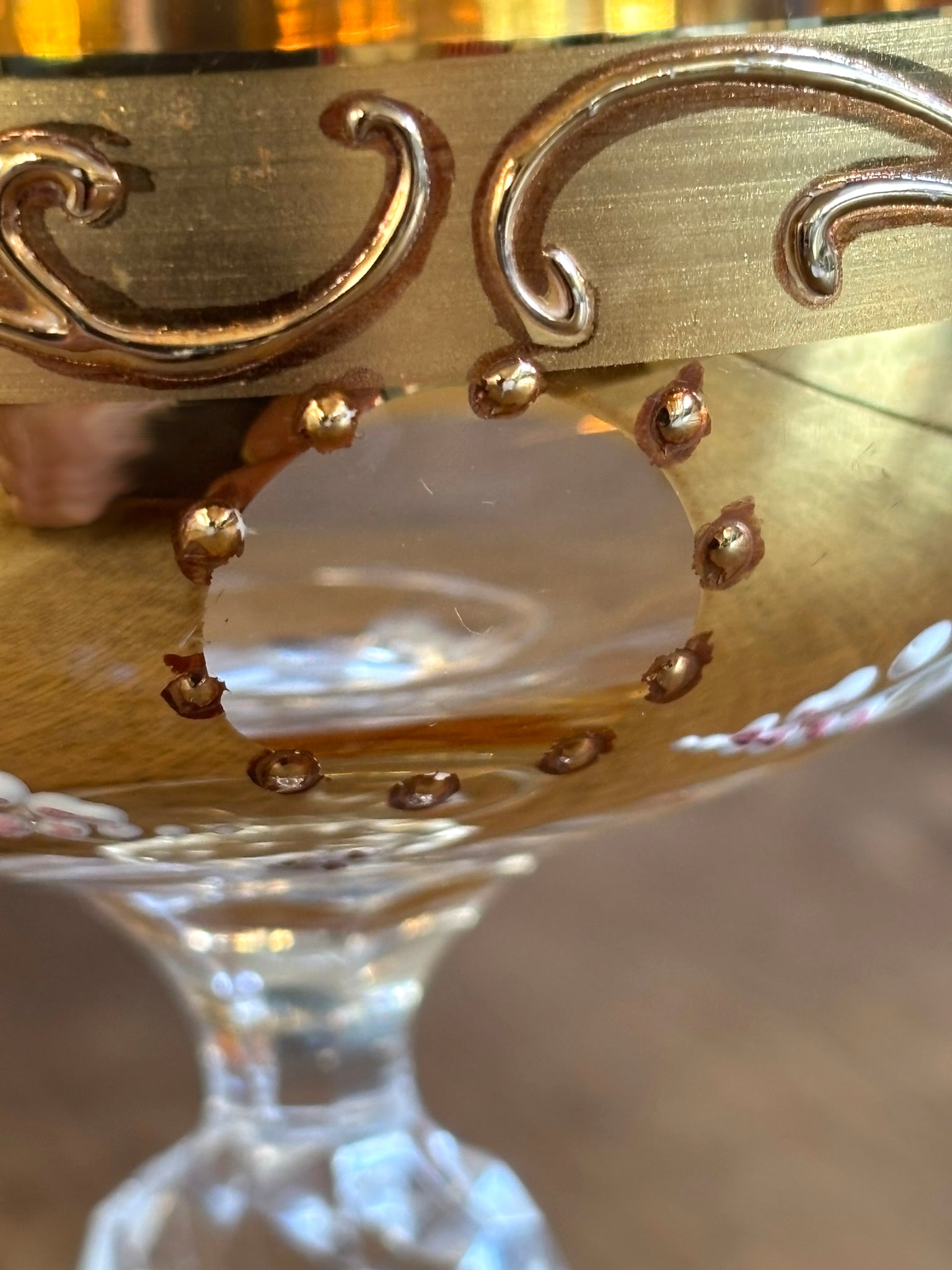 Close-up of a decorative Murano goblet with gold accents and a central stone.