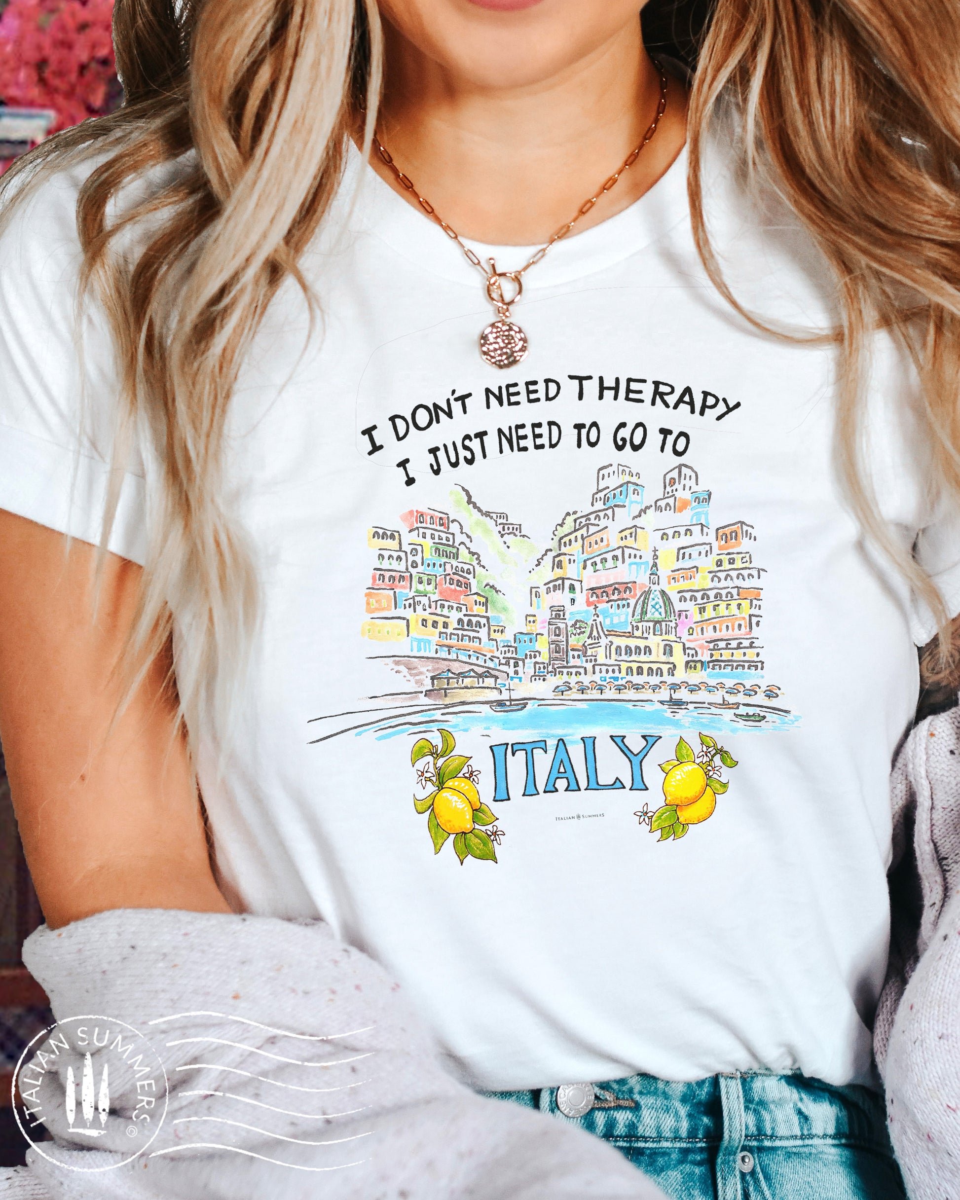 Italy and Amalfi Coast Inspired T Shirt with the hand-designed quote: I Don't need therapy I just need to go to Italy. A hand-drawing of the village of Positano with its colorful pastel  houses and terraces decorates this happy tee! Made by Italian Summers