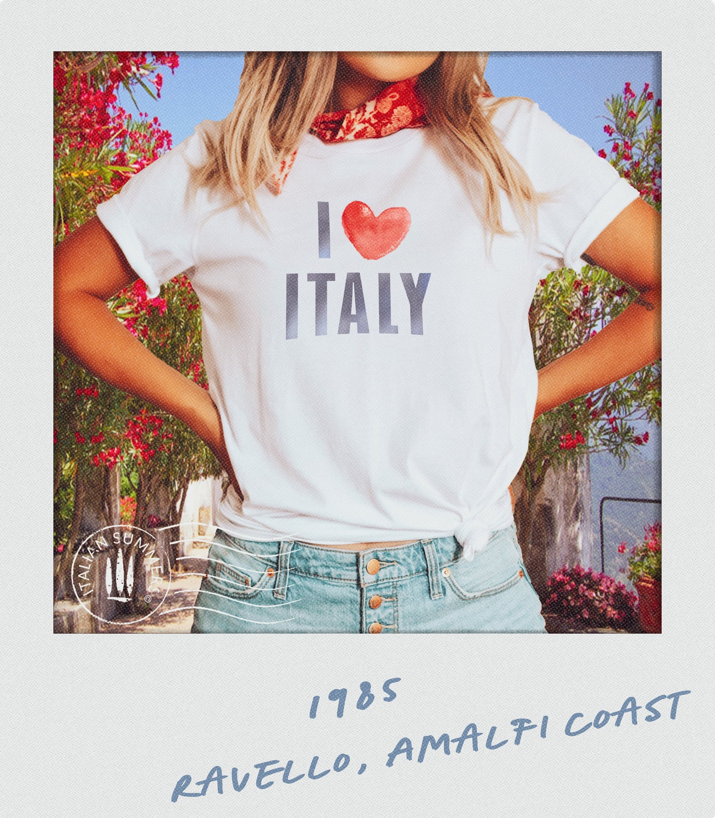 Italy-inspired white cotton T shirt with the blue all-capitals watercolor text "I Love Italy" ,   the word love is symbolized by a watercolor red heart. Made by Italian Summers