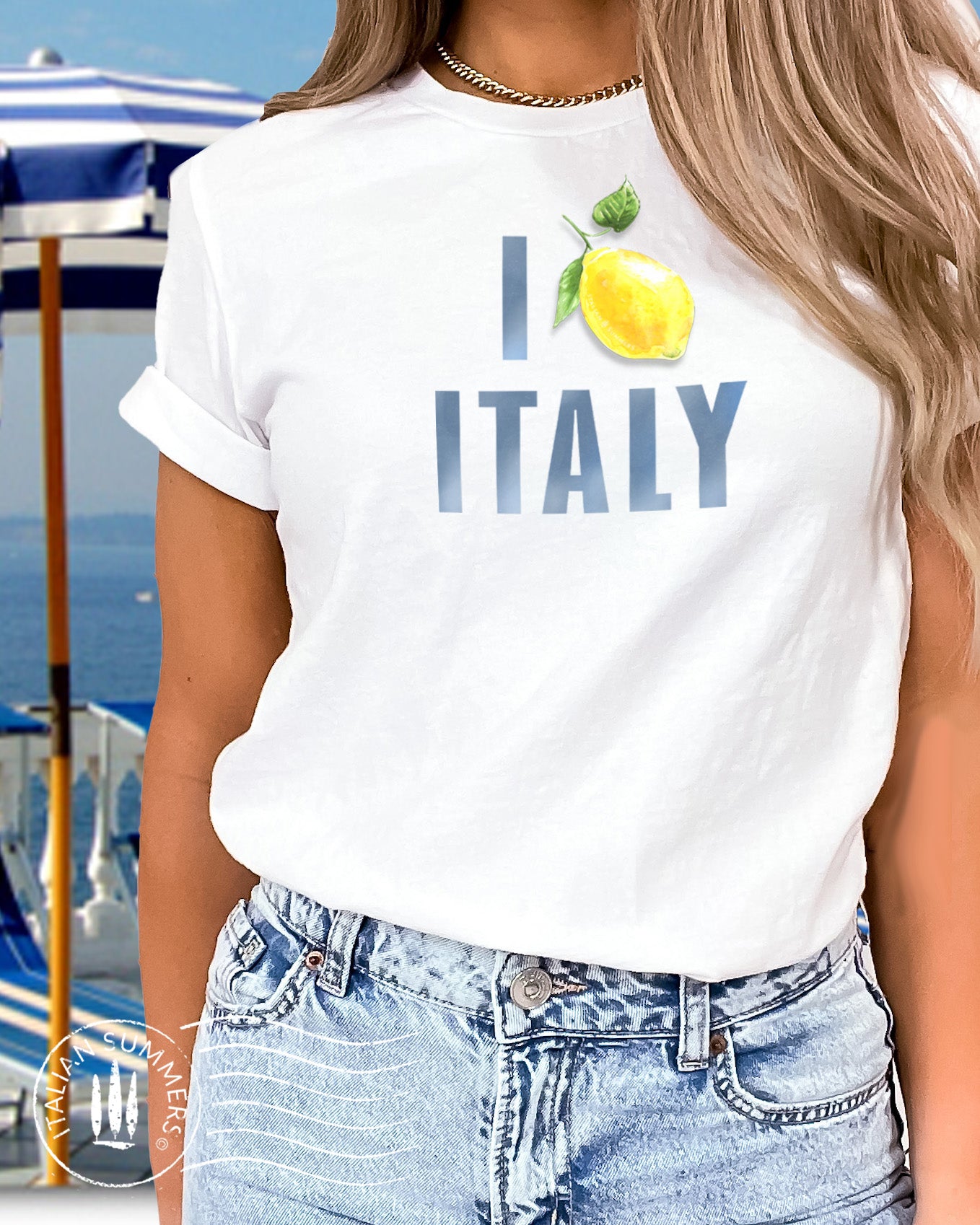 Italy Inspired white cotton unisex T shirt with the watercolored blue text : I Love Italy" where the word Love is symbolized by aan Amalfi Coast lemon instead of a red heart. Made by Italian Summers