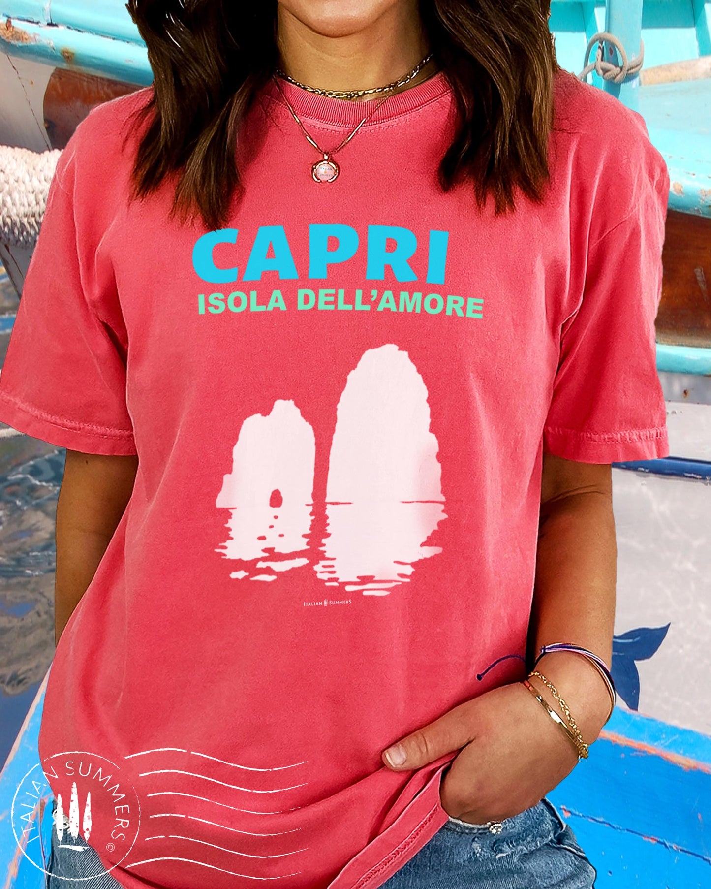 Italy inspired garment dyed T shirt with the aqua and white text: CAPRI, Isola dell'Amore (Capri, Iland of Love) with the silhouette  of the famous Faraglioni and their reflection umpon the waters of the Mediterranean Sea. Made by Italian Summers