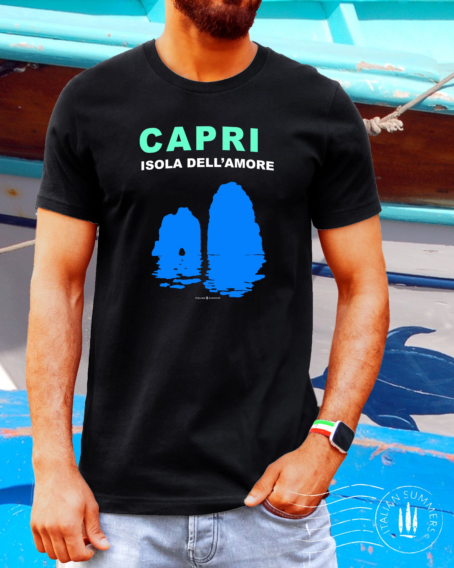 Italy inspired garment dyed T shirt with the aqua and white text: CAPRI, Isola dell'Amore (Capri, Iland of Love) with the silhouette  of the famous Faraglioni and their reflection umpon the waters of the Mediterranean Sea. Made by Italian Summers