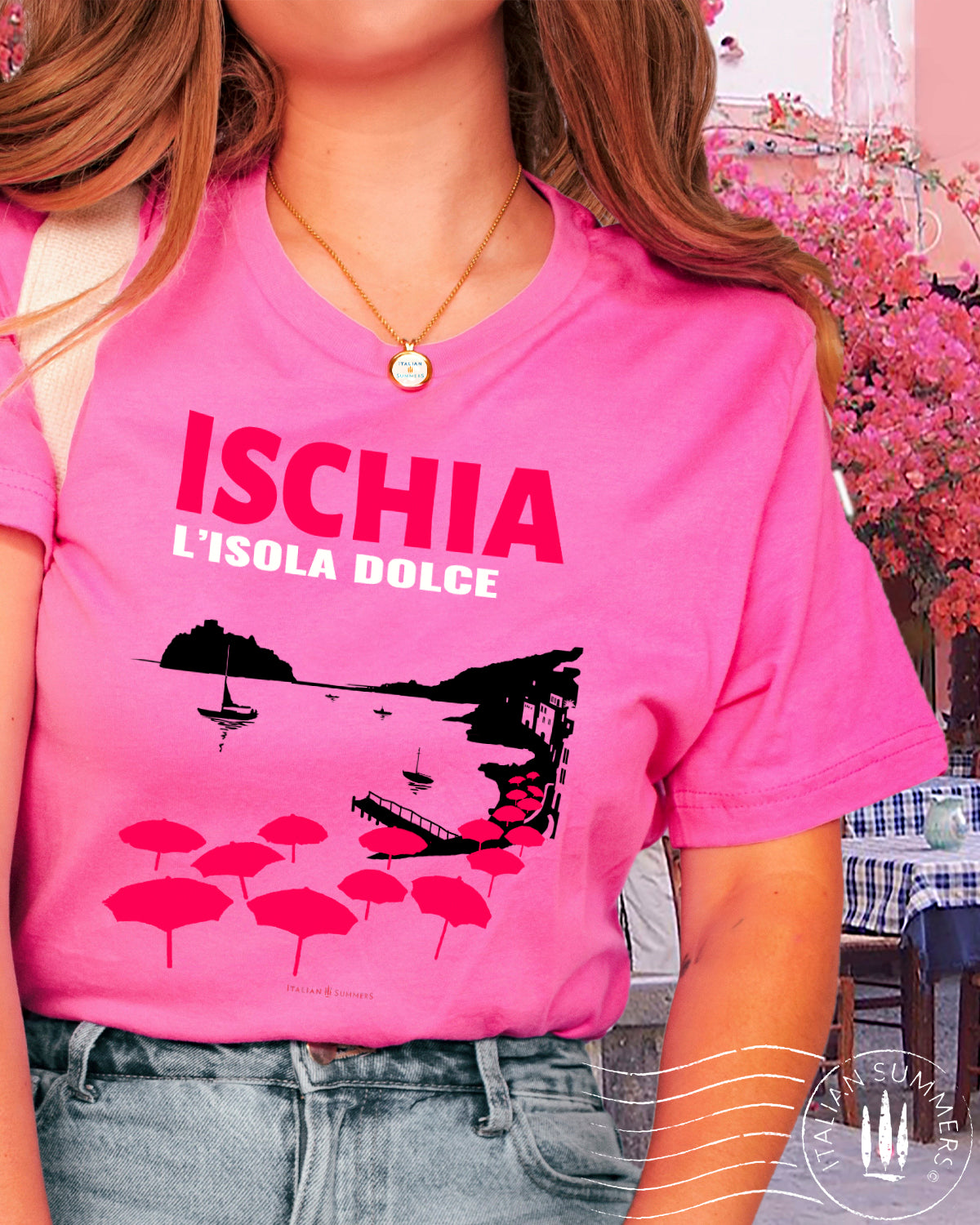Italy Inspired garment dyed T Shirt with the text: ISCHIA L'isola dolce (Ischia, the sweet island)  with the print of the island's beach with the famous Aragonese Castle in the backround, with colored beach umbrellas strewn in the foreground. Made by Italian Summers