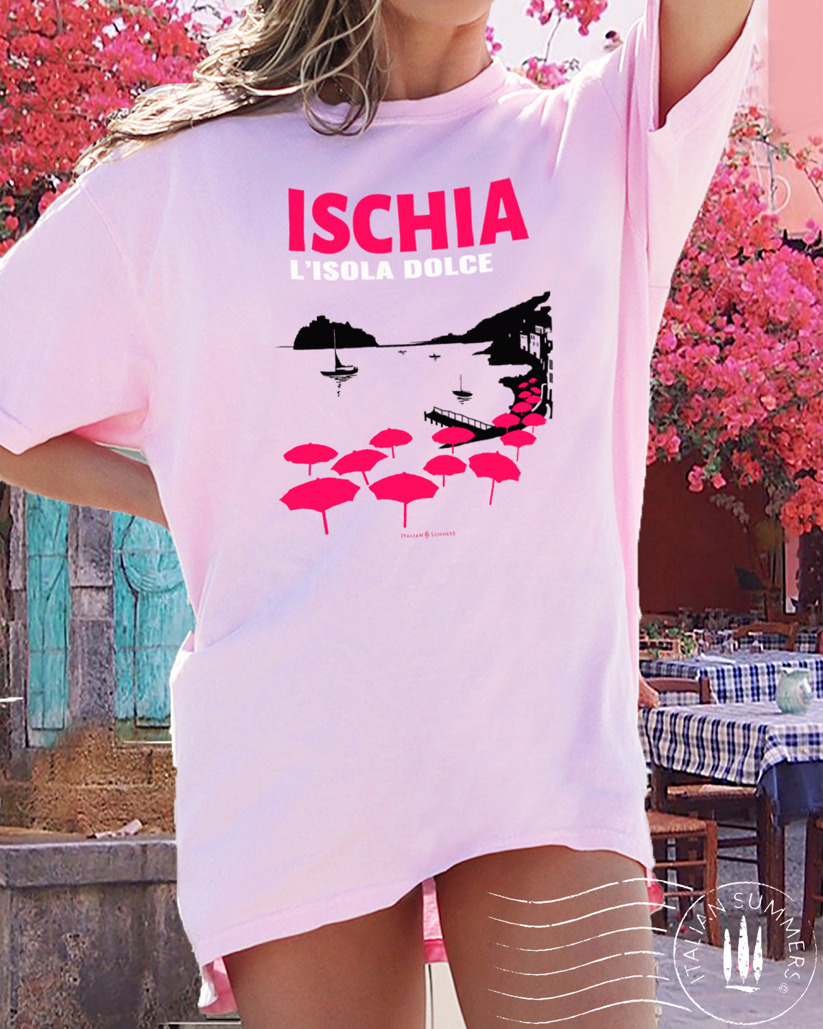 Italy Inspired garment dyed T Shirt with the text: ISCHIA L'isola dolce (Ischia, the sweet island)  with the print of the island's beach with the famous Aragonese Castle in the backround, with colored beach umbrellas strewn in the foreground. Made by Italian Summers