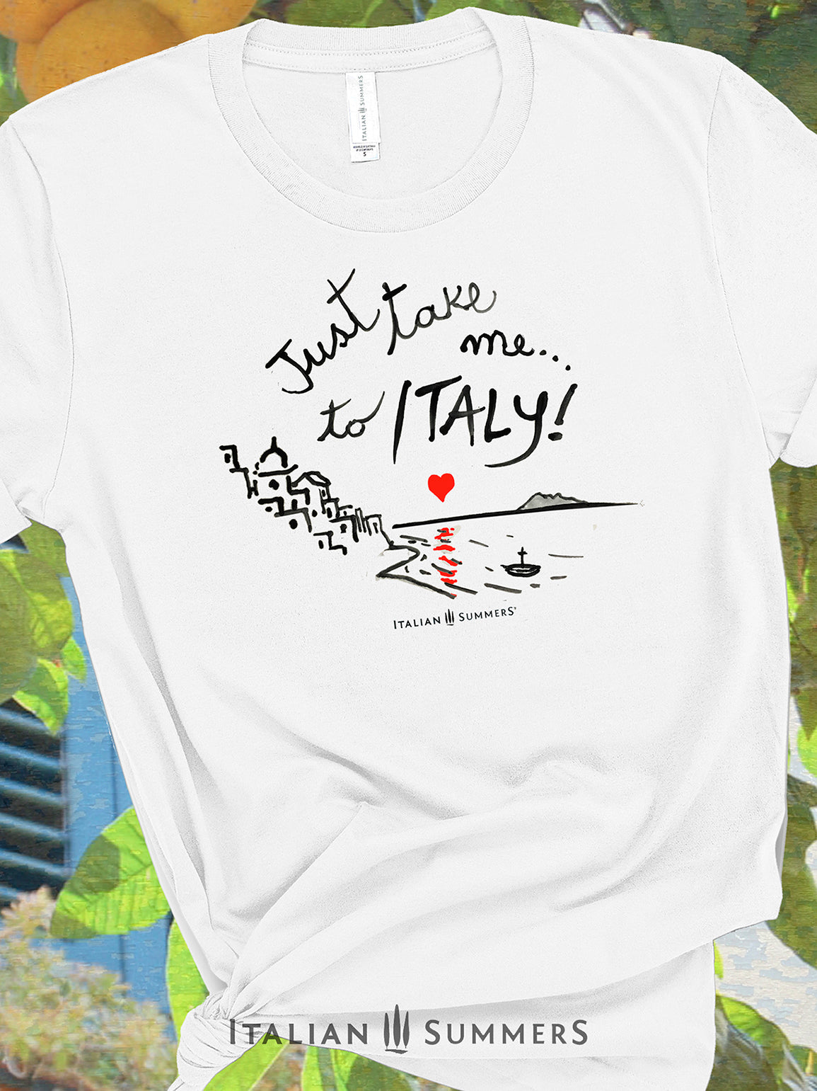 Italy-inspired Unisex crew neck T shirt with a prit of a hand-painted  stylized Amalfi Coast village with a red heart setting on the sea and reflecting its glow on the waters. The hand-painted phrase "Just take me to Italy" is above the composition