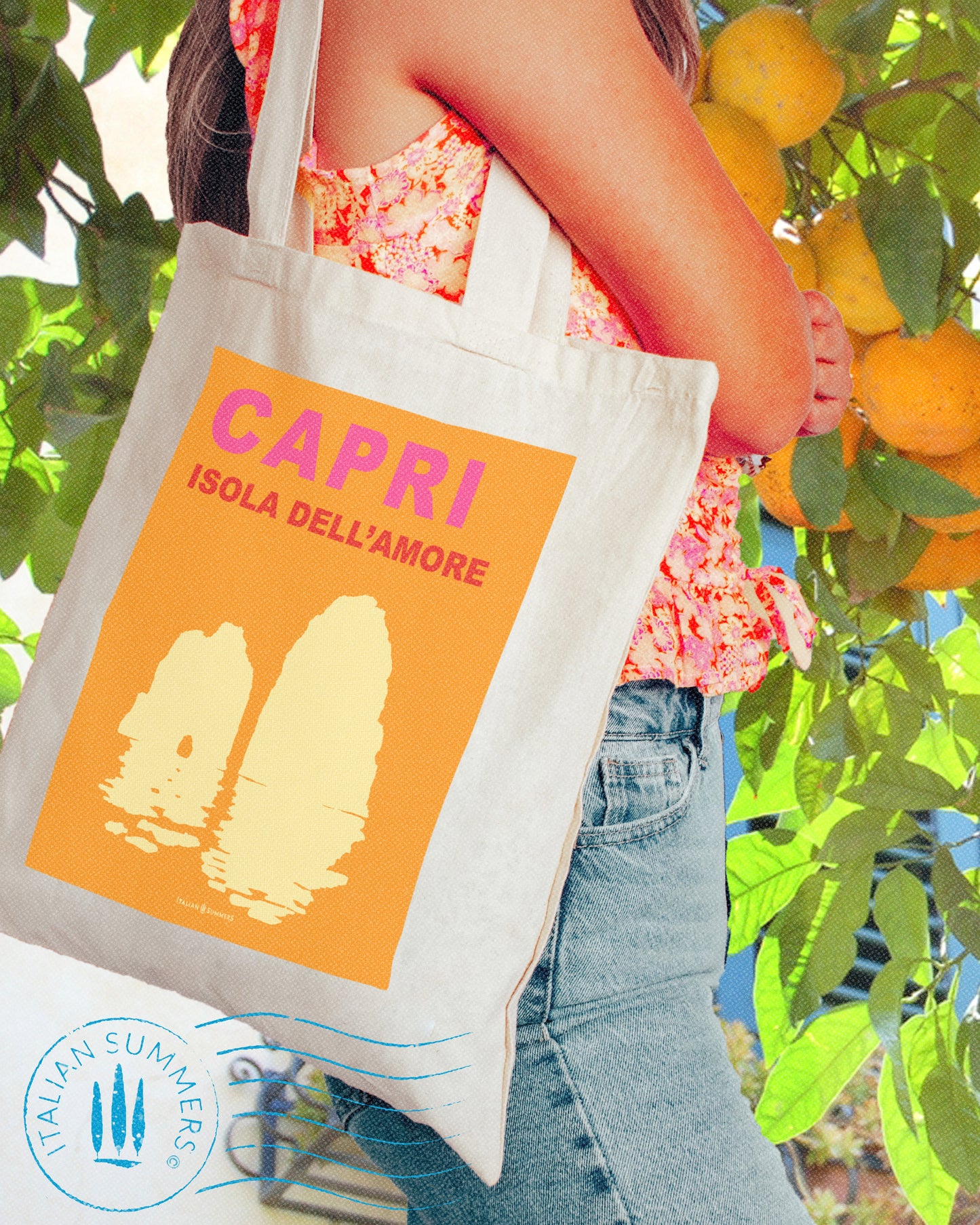 Italy inspired tote bag that represents an orange field containing a watm fuchsia Capri text and under that the text Isola del Amore means Isand of love. Under the text there is the silhouet of the Faraglioni in light warm color. Designed by Italian Summers