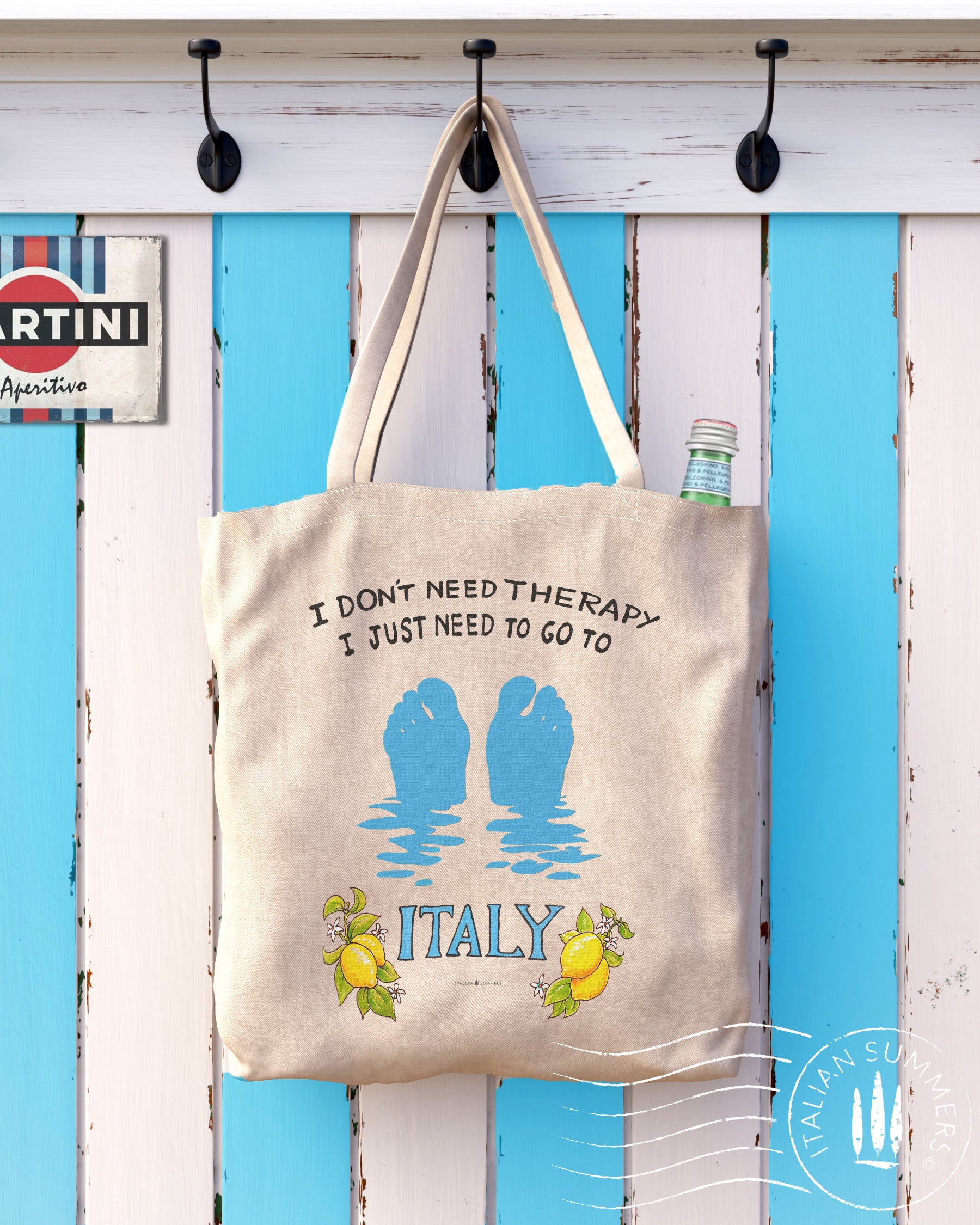 An Italy inspired cotton tote bag. It features our favorite illustrated Italy quote I don't need therapy, I just need to go to Italy with lemons and a blue 'ITALY'. We added the azure silhouette of two floating footsies just sticking out of the waters of the Mediterranean Sea! Designed by Italian Summers
