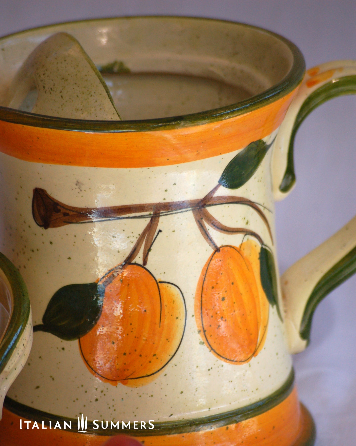 Ceramic pitcher with orange and green design, featuring 'Italian Summers' branding.