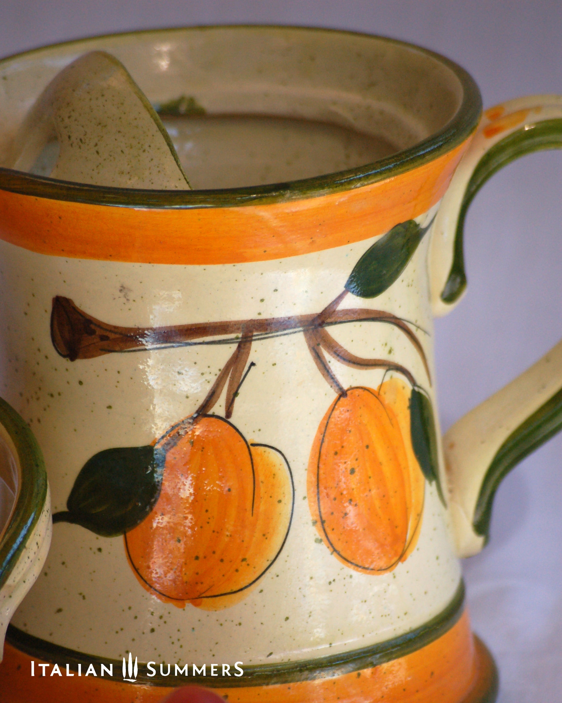 Ceramic pitcher with orange and green design, featuring 'Italian Summers' branding.