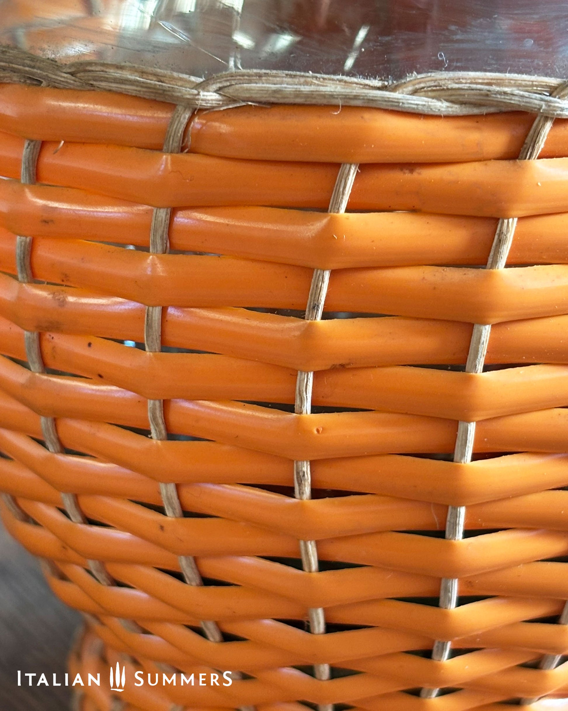 Close-up of an orange woven basket with 'Italian Summers' branding.