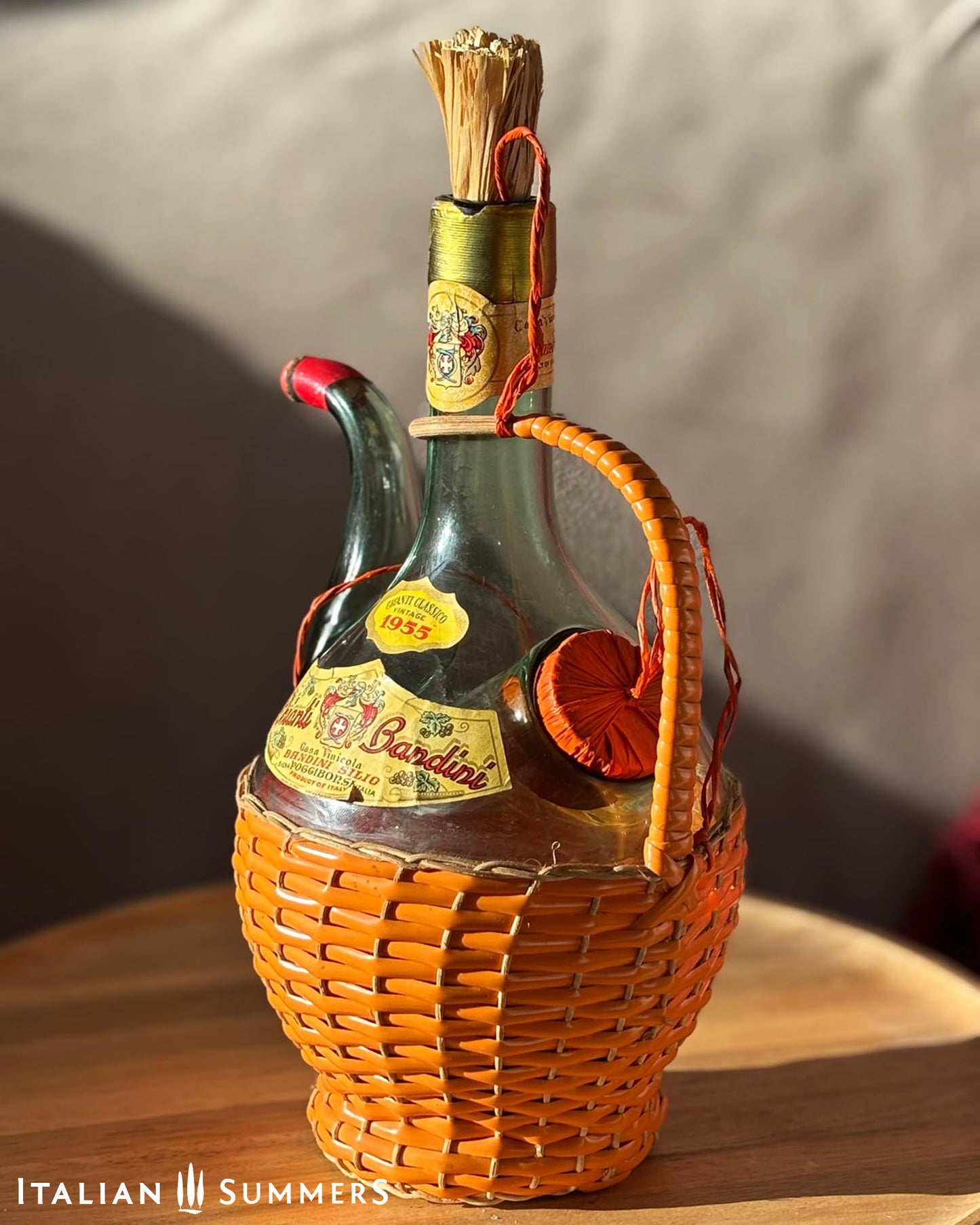 Vintage bottle with wicker holder and Rardin label on a wooden surface