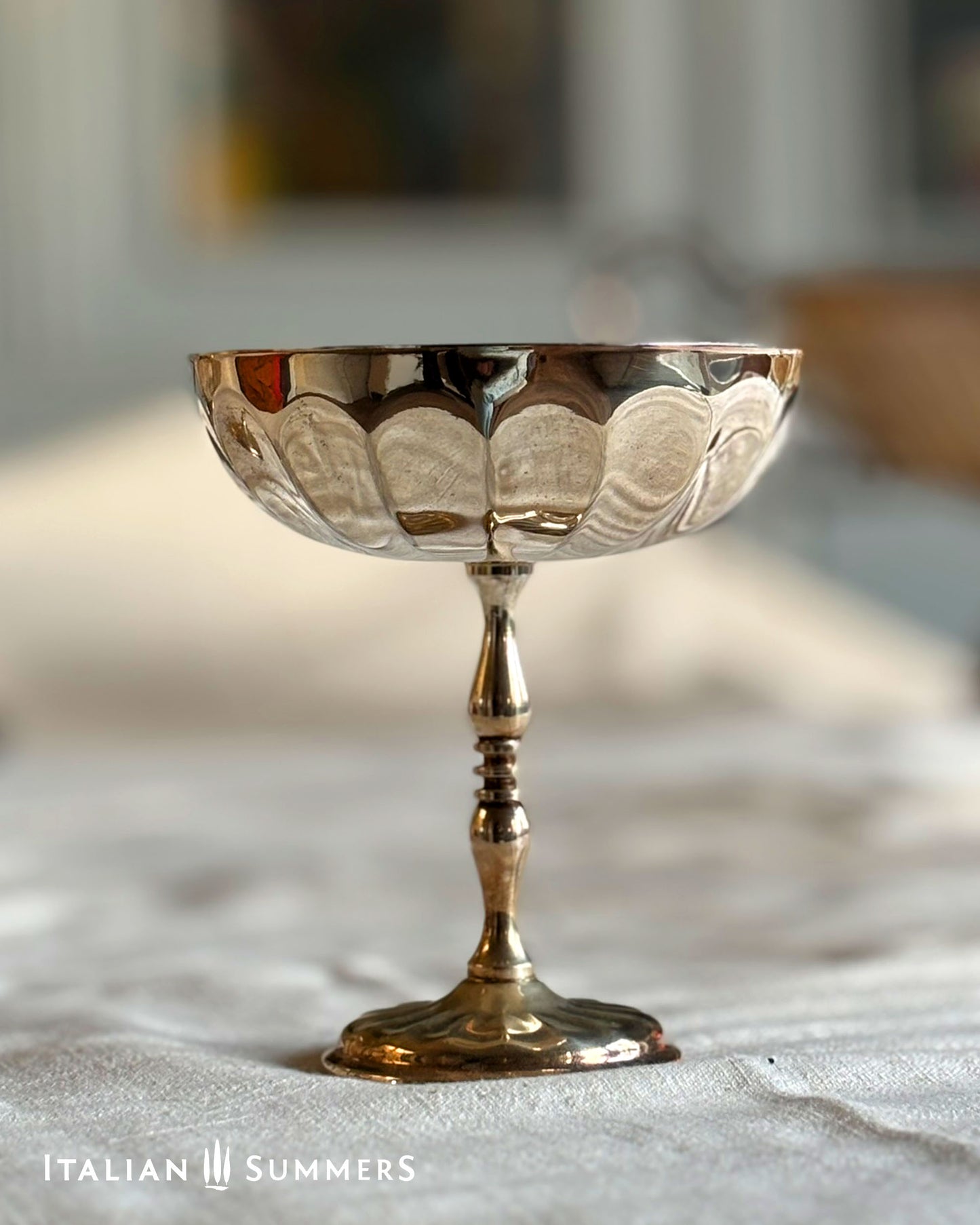 Decorative silver goblet on a textured surface with 'Italian Summers' branding.