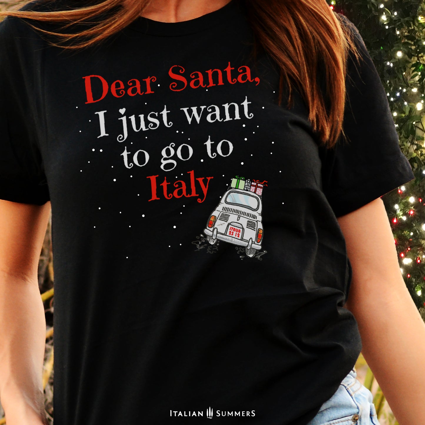 Christmas t-shirt Dear Santa  I just want to go to Italy by Italian Summers. Our bestseller Italy Chirstmas shirt with the quote and a sketch of a Fiat 500 with presents on the roof driving on its way to Italy while snow is falling!