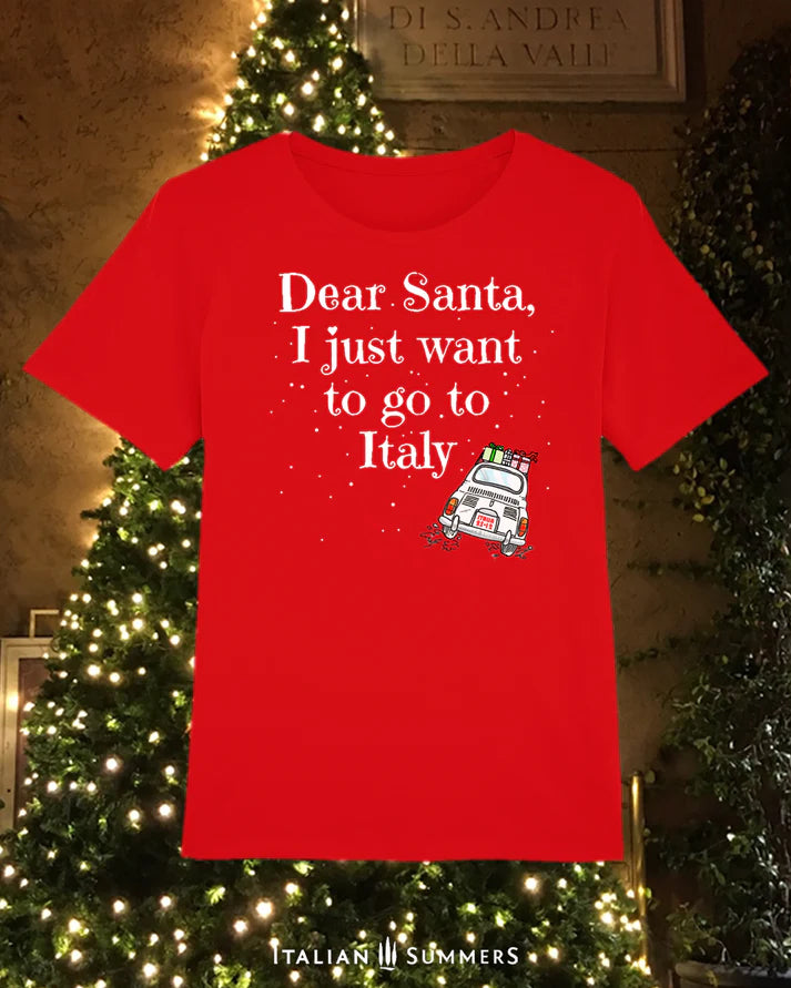 Italy Christmas red T shirt featuring a cute vintage Fiat car loaded with gifts and driving away in the snow. A large text states: " Dear Santa  I just want to go to Italy"