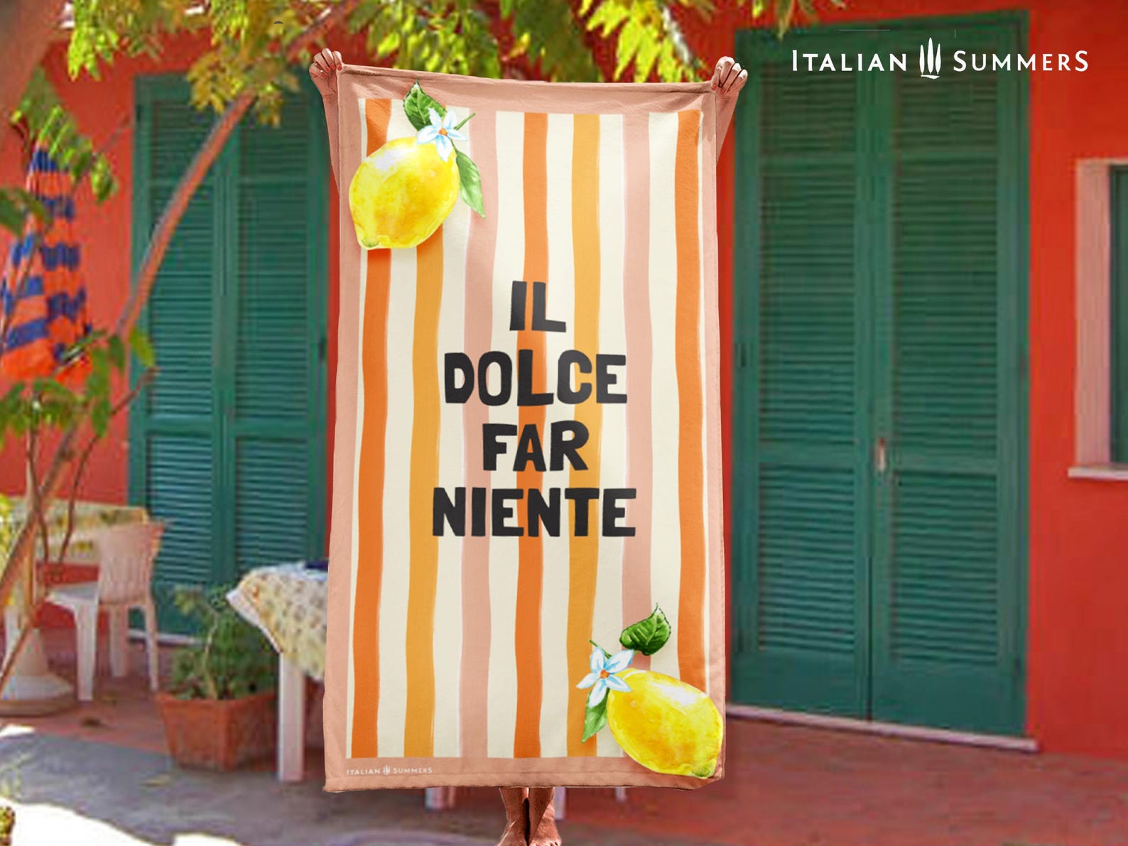 A retro-inspired Italian beach towel with pink and orange watercolor stripes, the phrase “Il Dolce Far Niente,” and two bright lemons in the corners—ideal for quick drying and an Italy vacation.