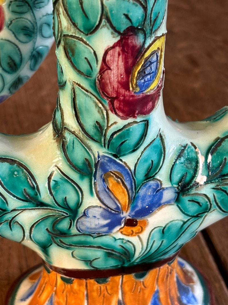 Decorative cerart candleholder  with floral patterns on a wooden surface