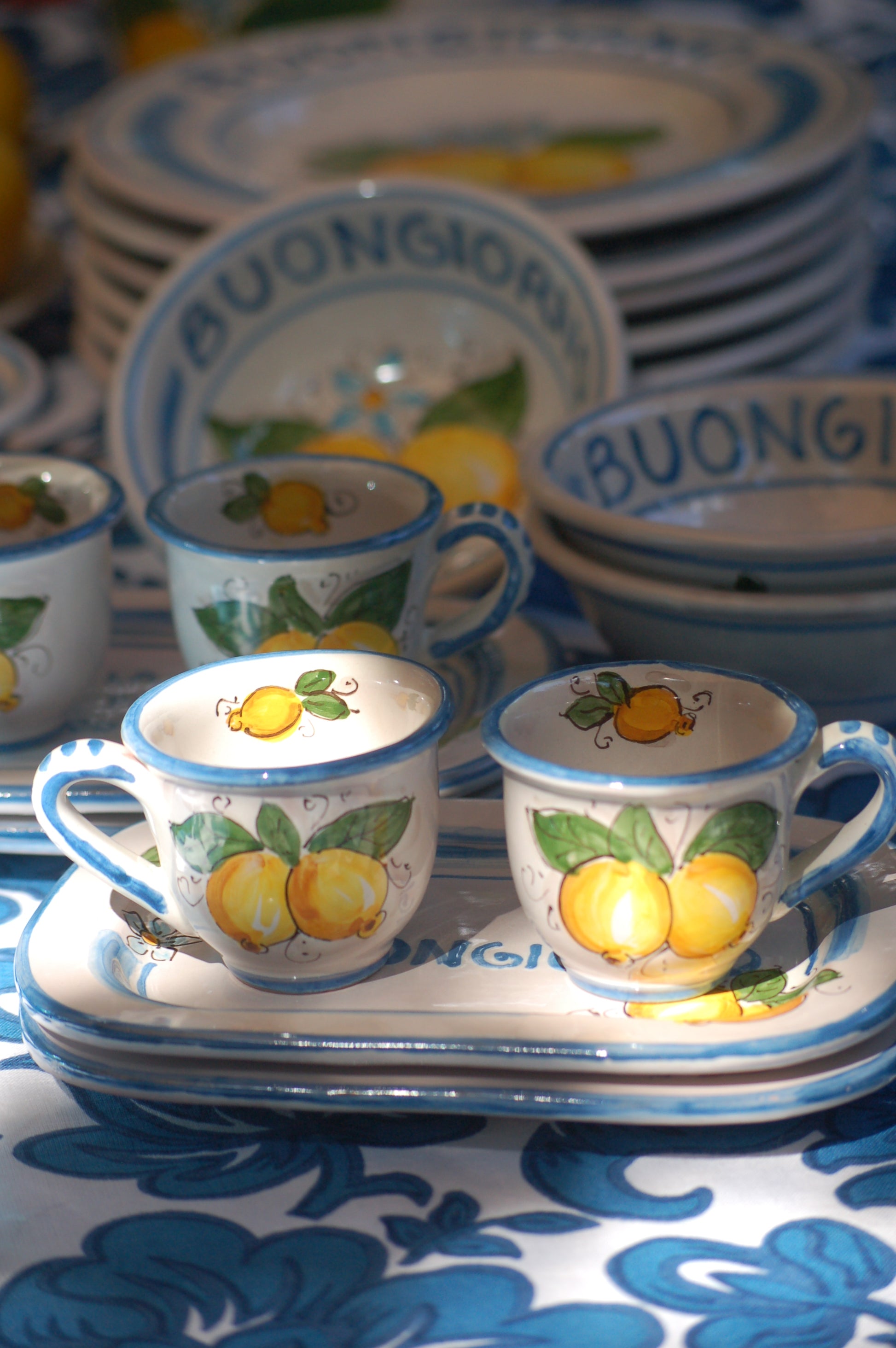 Italian ceramic breakfast set made up of two espresso cups with a tray, and wo bowls. All decorated with light marine blue stripes and vibrant hand painted Amalfi Coast lemons. The tray has the tex: "La vita e' piu bella con te" (life is more beautiful with you) or "Buongiorno" Artisan-made on the island of Sicily