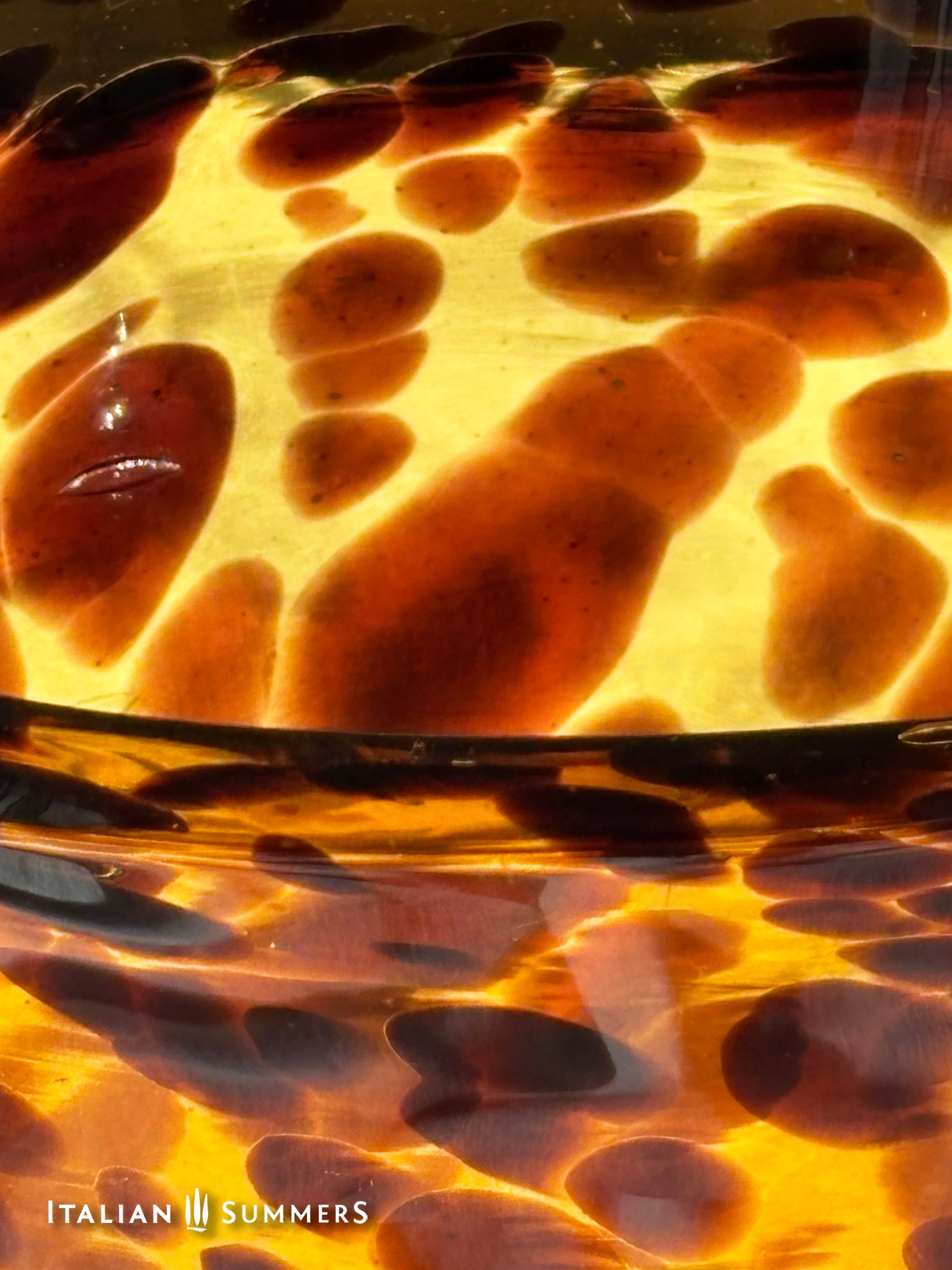 Close-up of a tortoiseshell pattern with 'Italian Summers' branding.